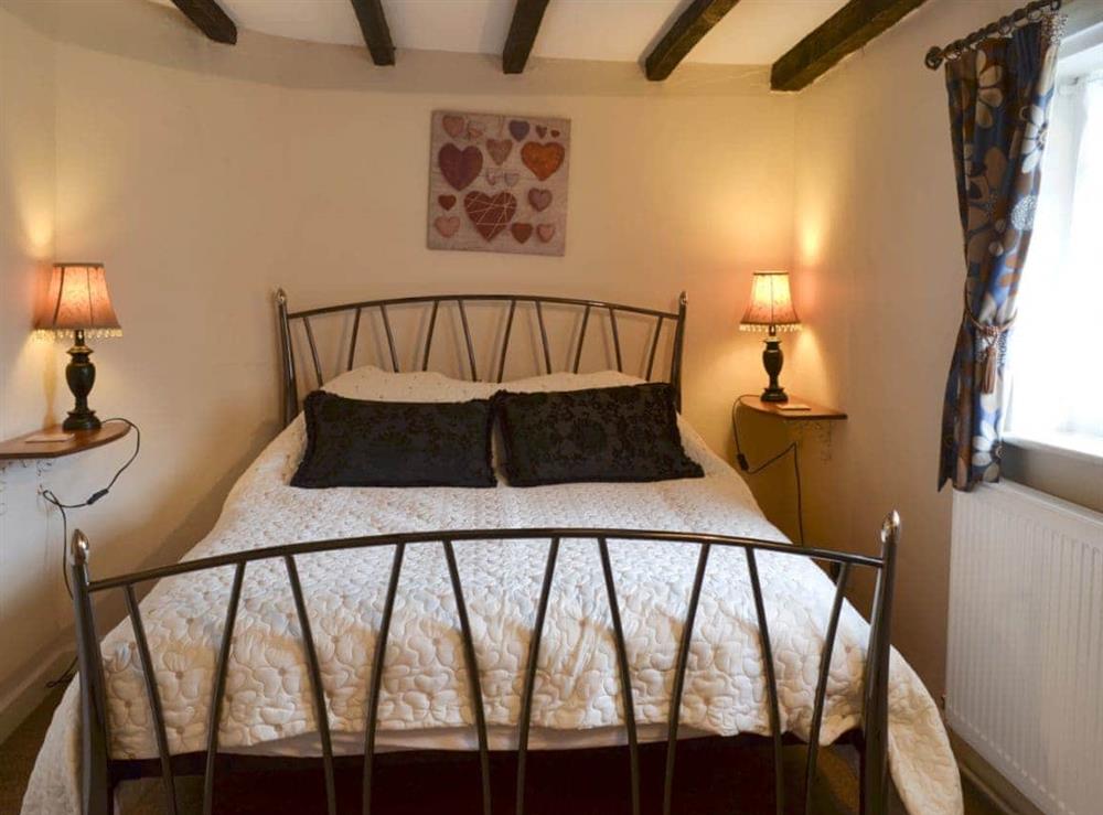 Double bedroom with beams at Childe of Hale Cottage in Hale Village, Merseyside