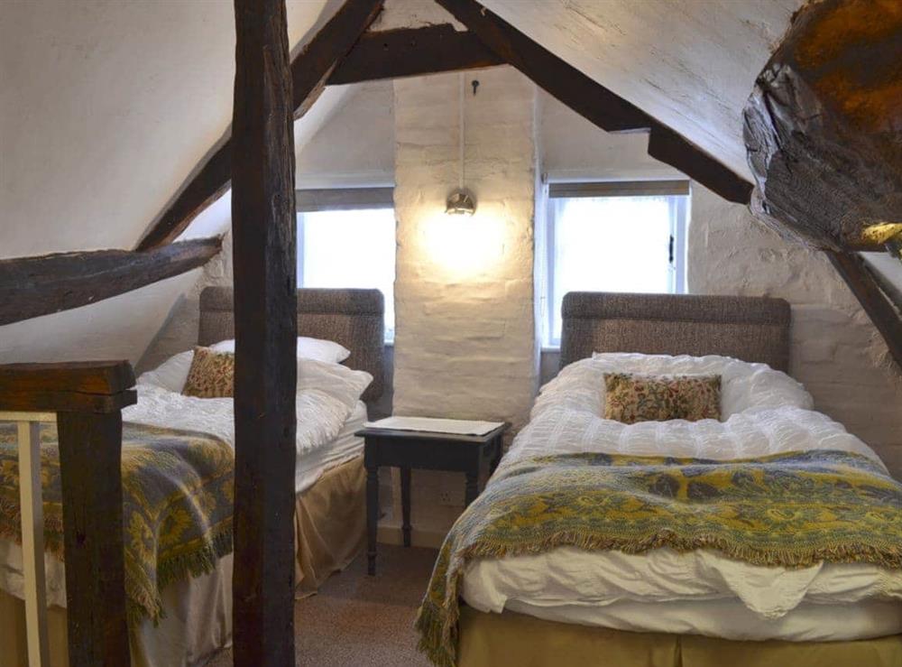Twin bedroom with beams at Childe of Hale Cottage in Hale Village, Merseyside