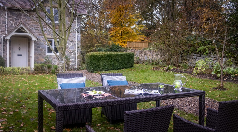 The outdoor dining table in the front garden at Chirk Home Farm Cottage in Chirk, Wrexham
