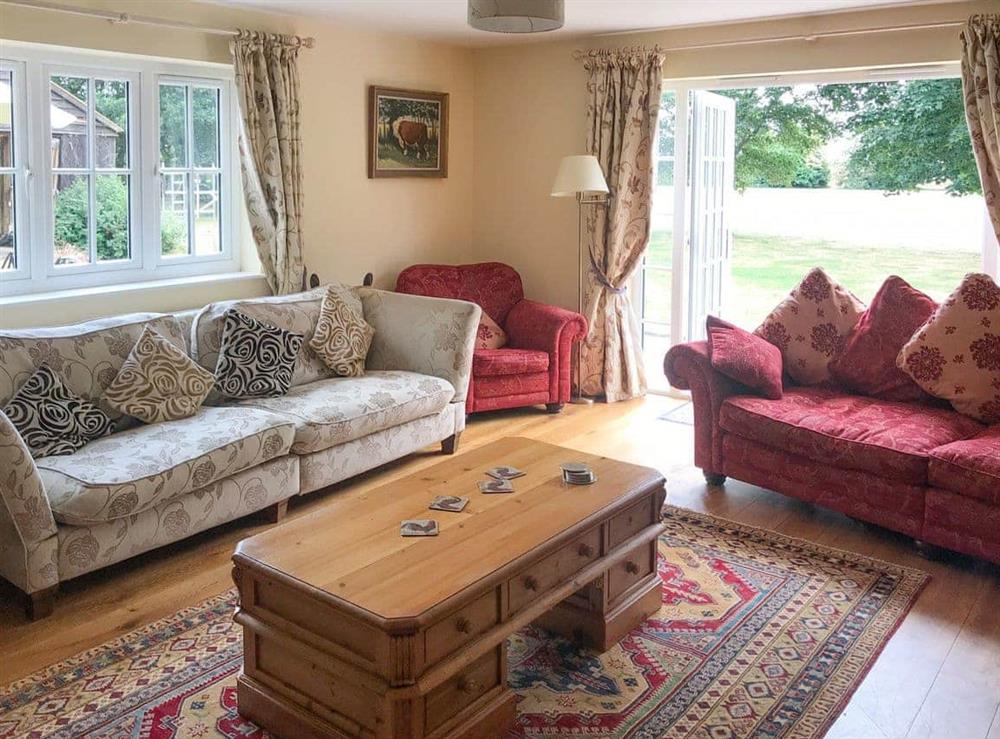 Spacious living room with bi-fold doors to garden at Chittering Farm in Stretham, Ely, Cambridgeshire., Great Britain