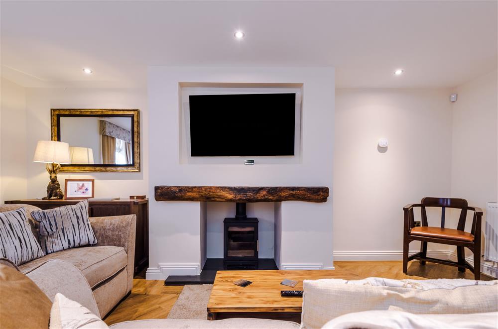 Relax by the wood burning stove and Smart television in the sitting room