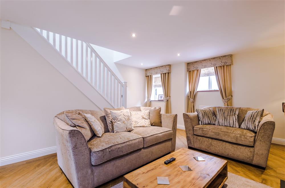 Sumptuous seating in the sitting room with stairs leading to the first floor