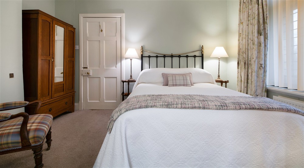 The ground floor bedroom has a double bed, with a shower and sink in the rooms alcove, Yorkshire at Choristers' House in Nr Ripon, North Yorkshire