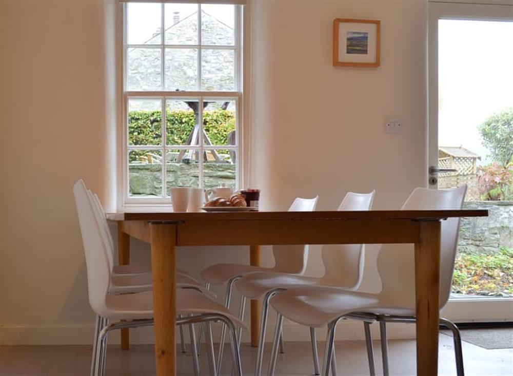 Dining table and chairs next to the back door to the garden at Church Cottage in Bakewell, Derbyshire