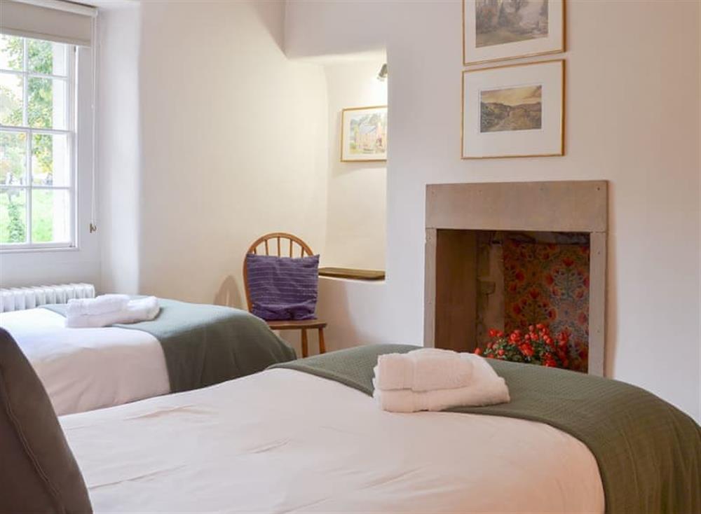 Twin bedroom with fireplace at Church Cottage in Bakewell, Derbyshire
