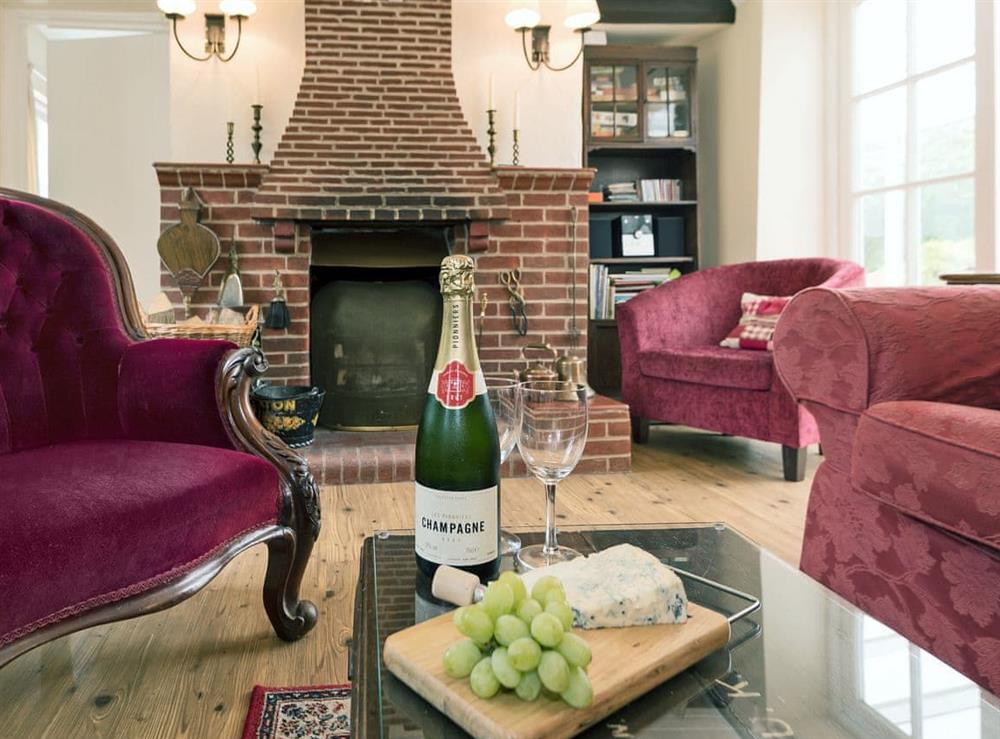 Cosy living area with open fire at Church Cottage in Denford, near Thrapston, Northamptonshire