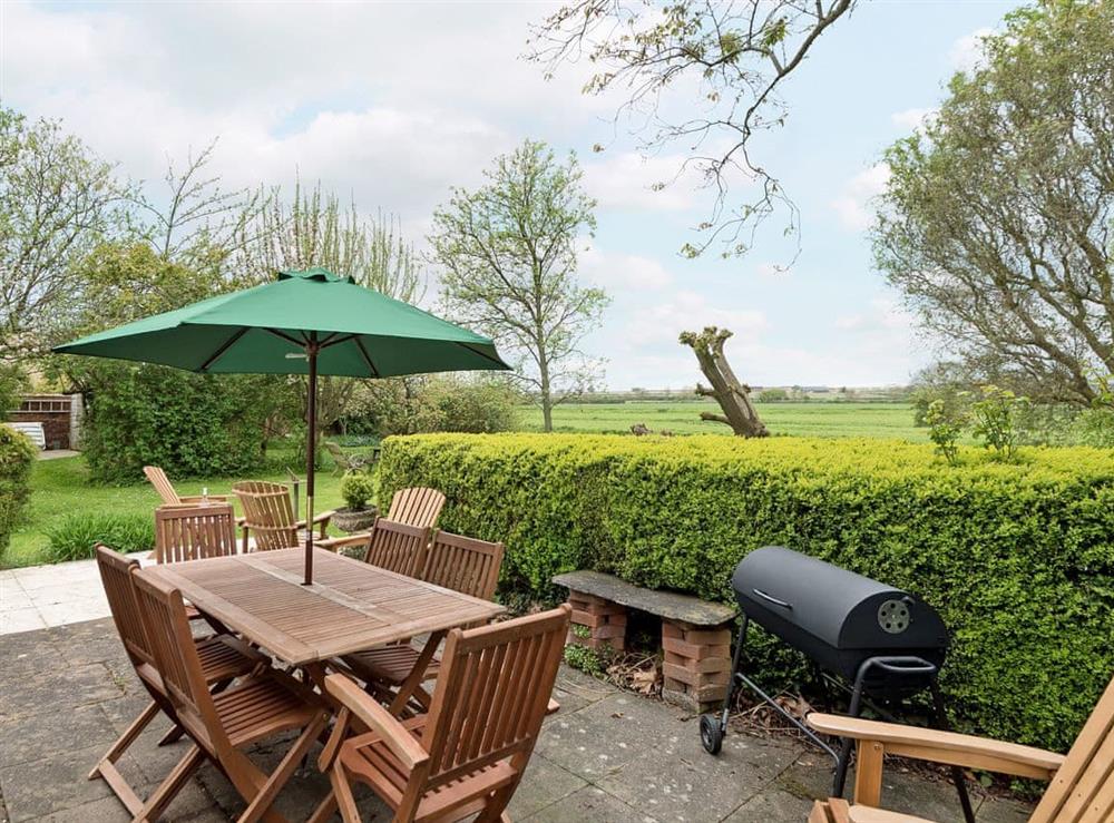 Peaceful patio area with BBQ at Church Cottage in Denford, near Thrapston, Northamptonshire