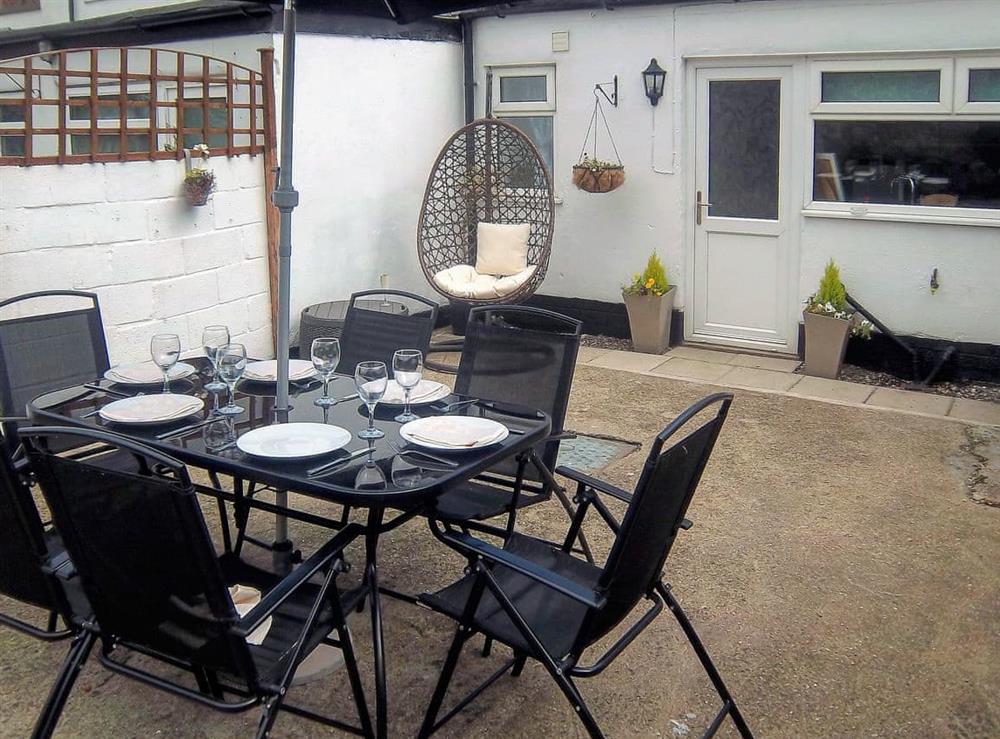 Enclosed courtyard with sitting-out area, garden furniture and barbecue (photo 3) at Church Court Cottage in Beeford, near Driffield, North Humberside