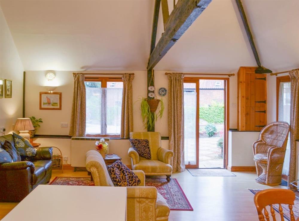 Comfortable open plan living area with exposed woodwork at Church Farm Studio in Surlingham, Norfolk