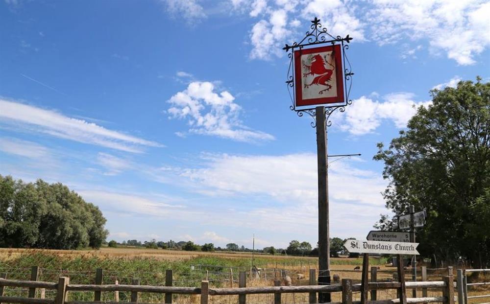 Fields and pub sign at Church Lodge, Snargate, Kent