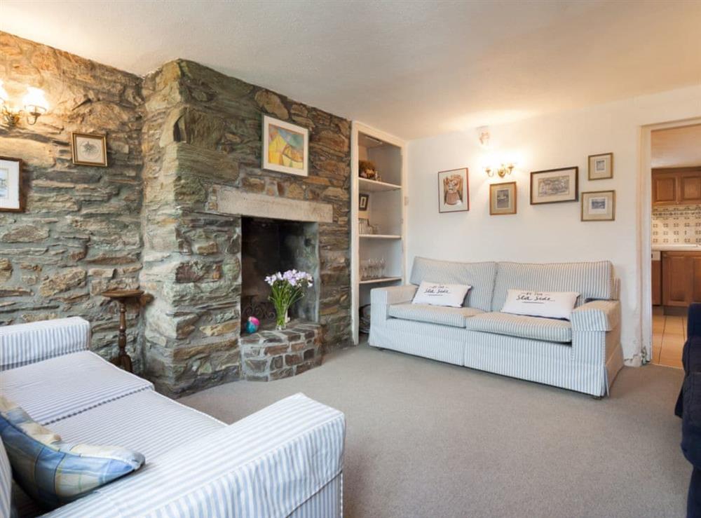 Main living room with stone clad feature fireplace at Church Street 17 in Salcombe, Devon