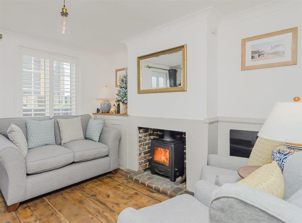 Comfortable living room with cosy wood burner at Church View Cottage in Goudhurst, England