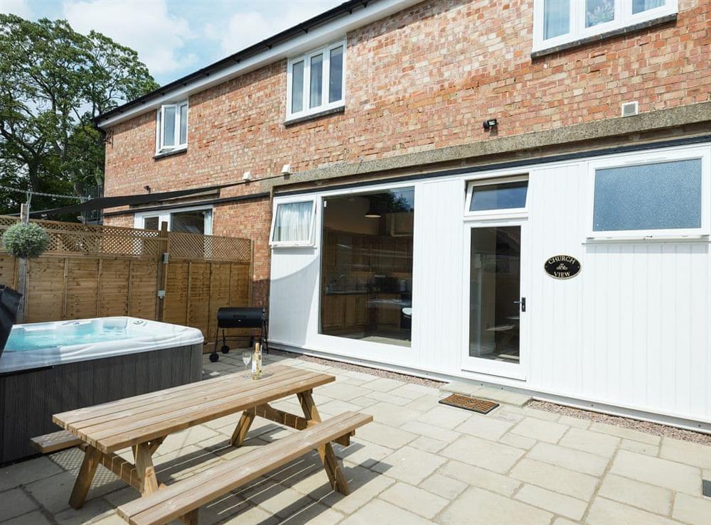 Impressive patio area with hot tub and BBQ at Church View in Wainfleet St. Mary, near Skegness, Lincolnshire