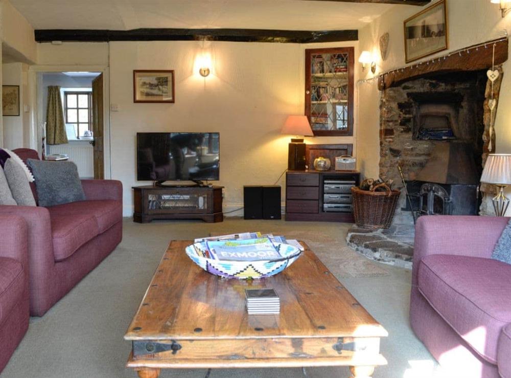 Living room with wood burner (photo 2) at Churchtown Farm Cottage in West Anstey, Devon
