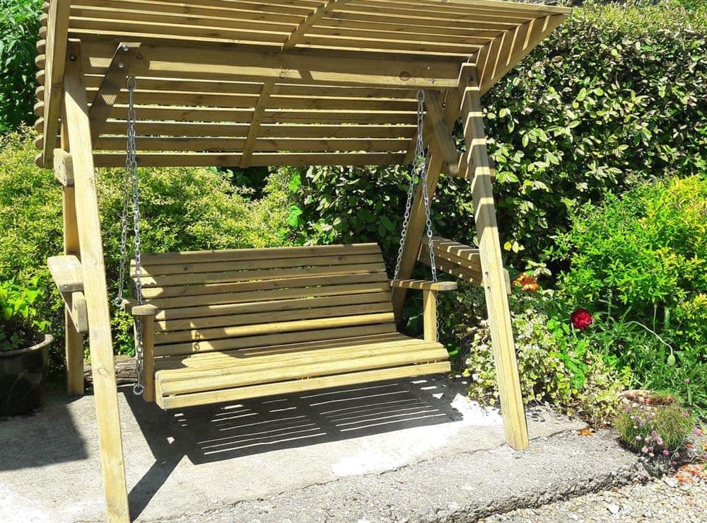 Garden seat on small patio area at Churchview House in Winterbourne Abbas, near Dorchester, Dorset