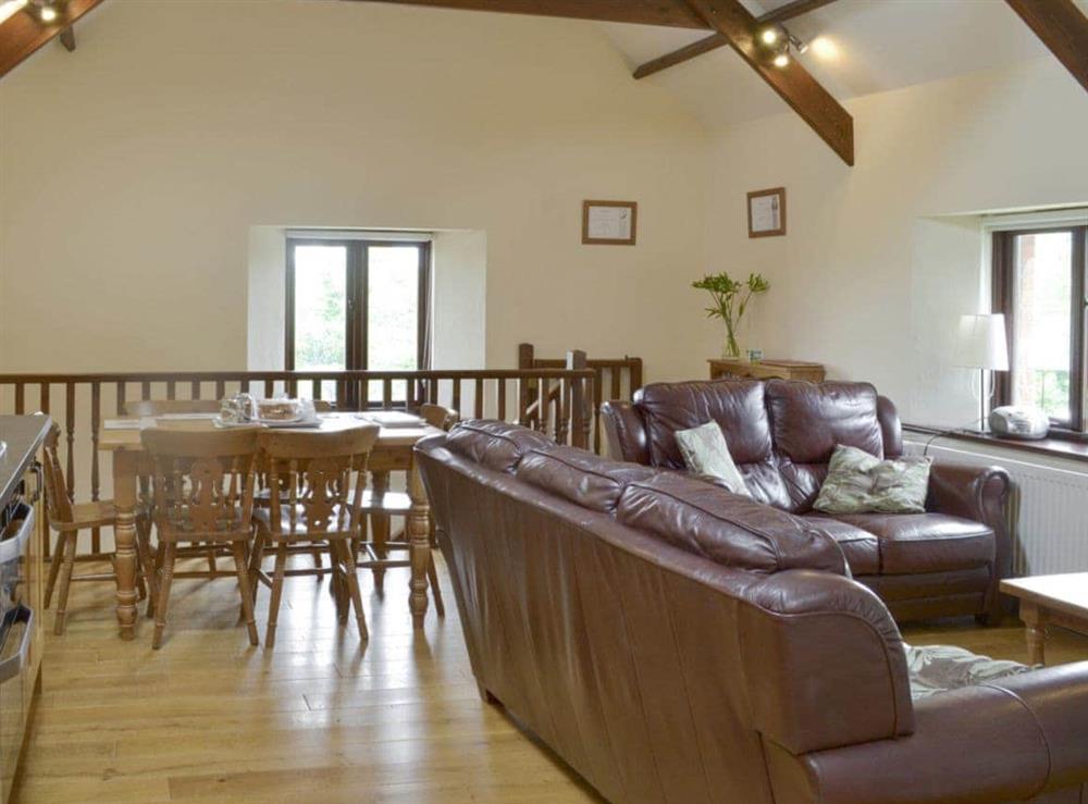 Exposed wood beams and wooden floors throughout living area at Cider Barn in Poundstock, Bude, Cornwall