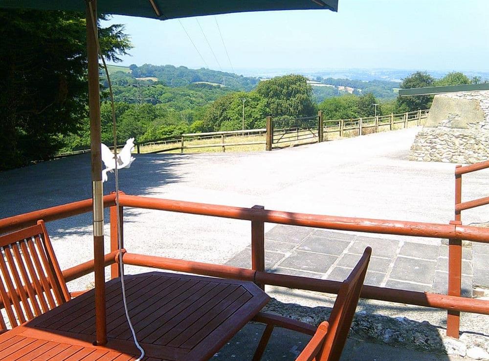 Enclosed raised patio with outdoor furniture at Cider Cottage in Hawkchurch, Nr Lyme Regis., Devon