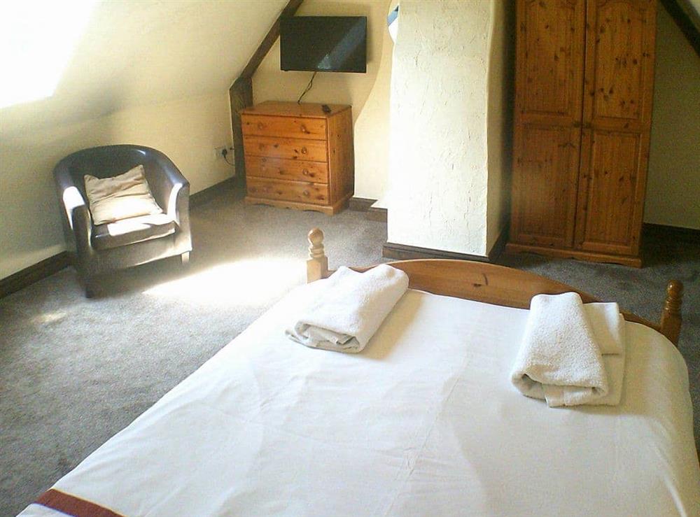 Spacious double bedroom with wall mounted TV at Cider Cottage in Hawkchurch, Nr Lyme Regis., Devon