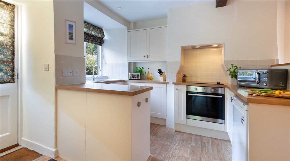 The kitchen area in the open-plan kitchen and dining room at Cider Cottage in Yelverton, Devon