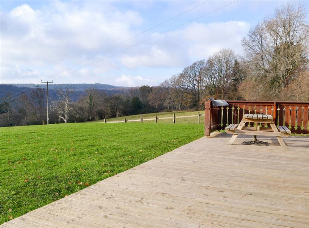 Decked terrace with outdoor furniture at Cider Mill Lodge in Chepstow, Gwent
