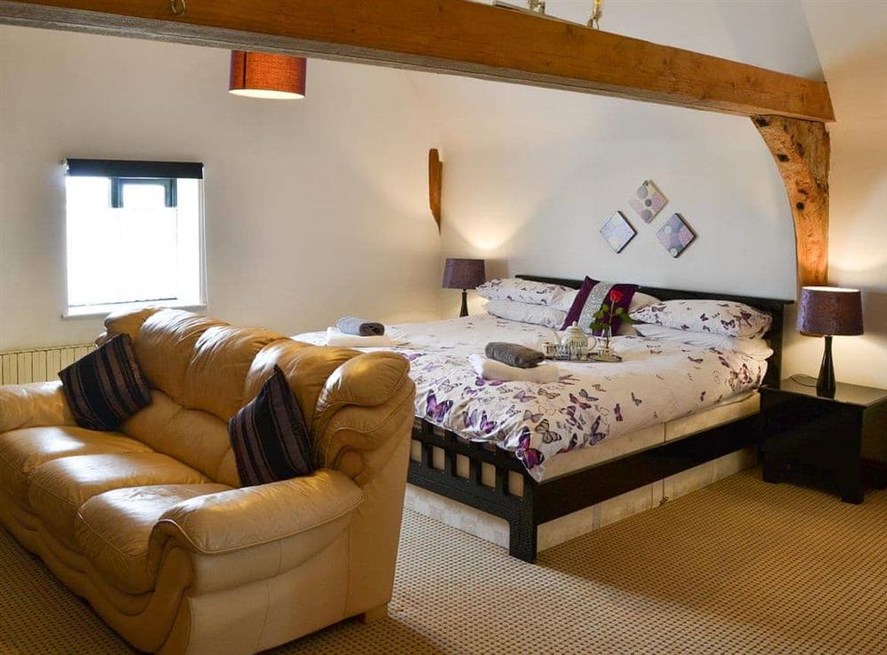 Double bedroom with seating area & en-suite at Clamp Farm Barn in Creeting St Peter, near Stowmarket, Suffolk
