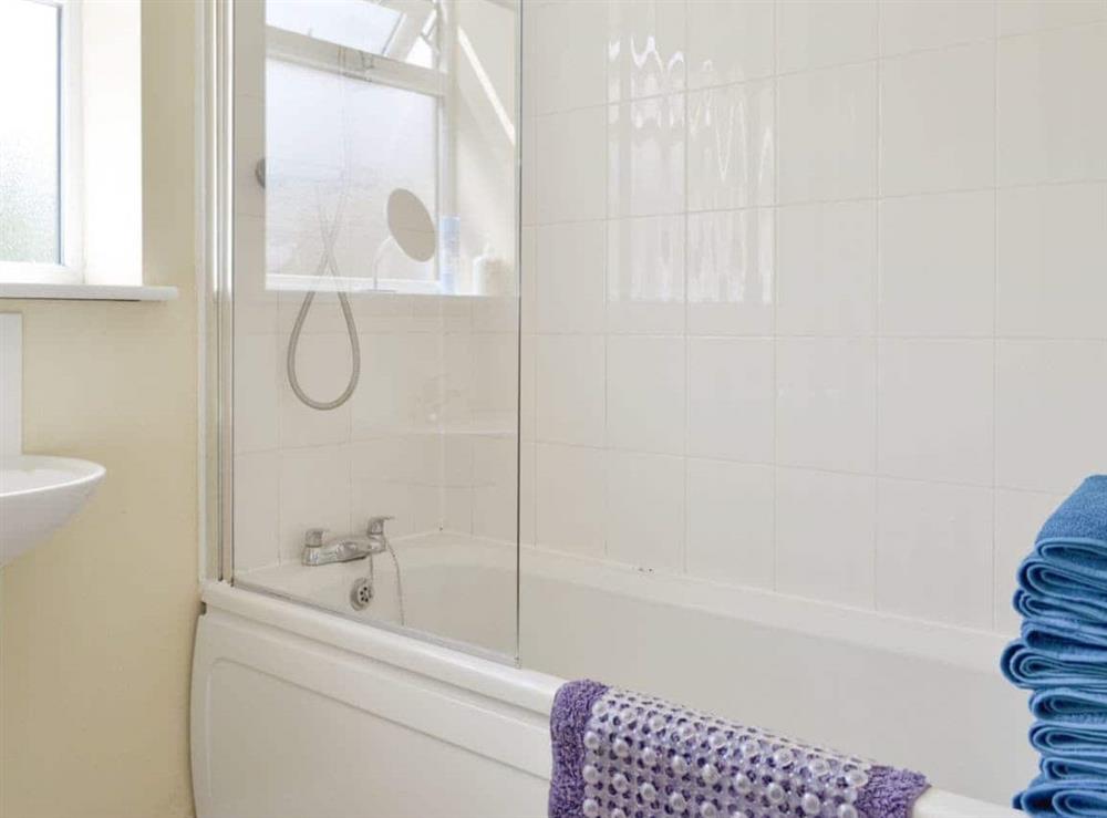 Family bathroom with shower over bath at Primrose, 