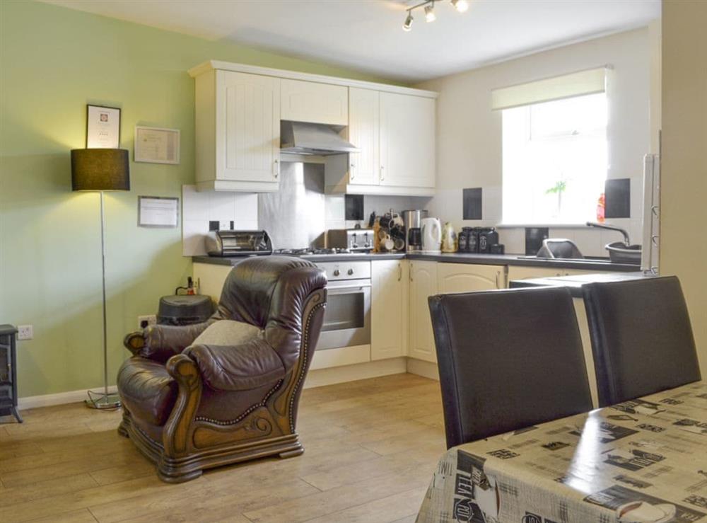 Convenient dining area within open-plan living space at Snowdrop Cottage, 