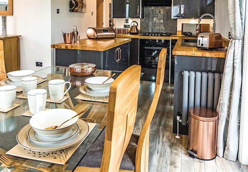 Dining area and kitchen in thel Lodge 3 at Clarach Bay Holiday Village in Clarach Bay, Nr Aberystwyth