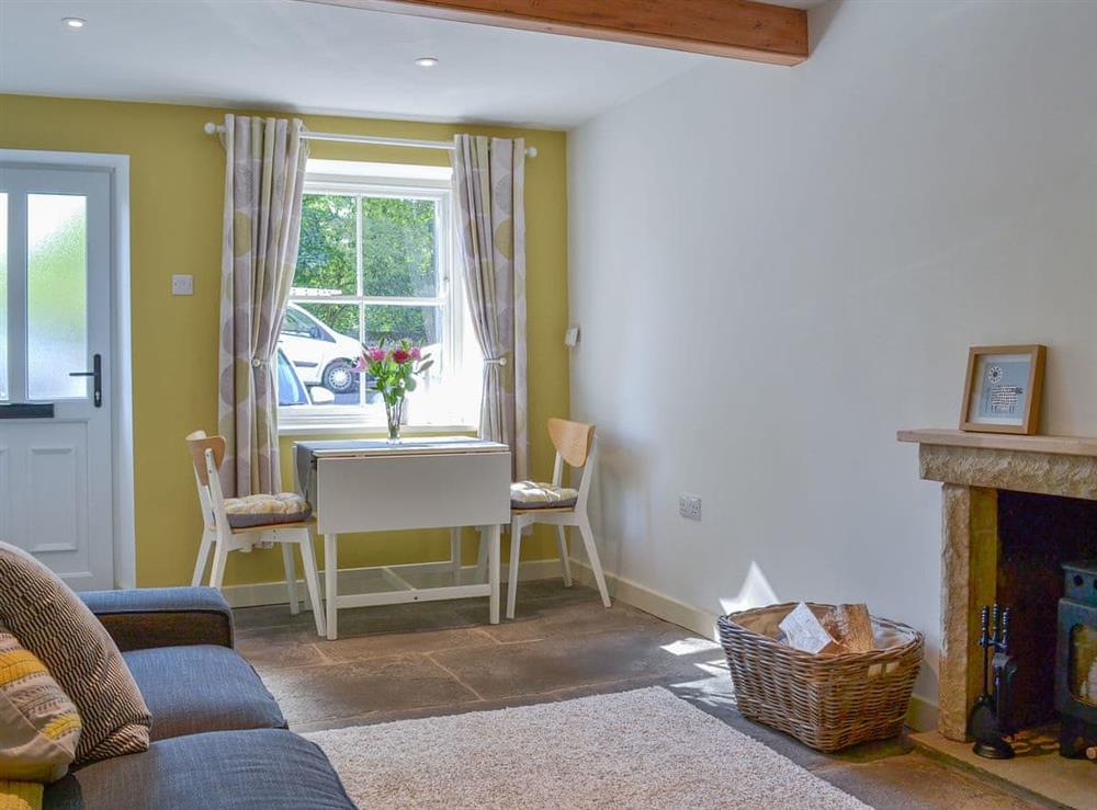 Beamed living area with woodburner at Clarence Cottage in Appleby-in-Westmorland, Cumbria