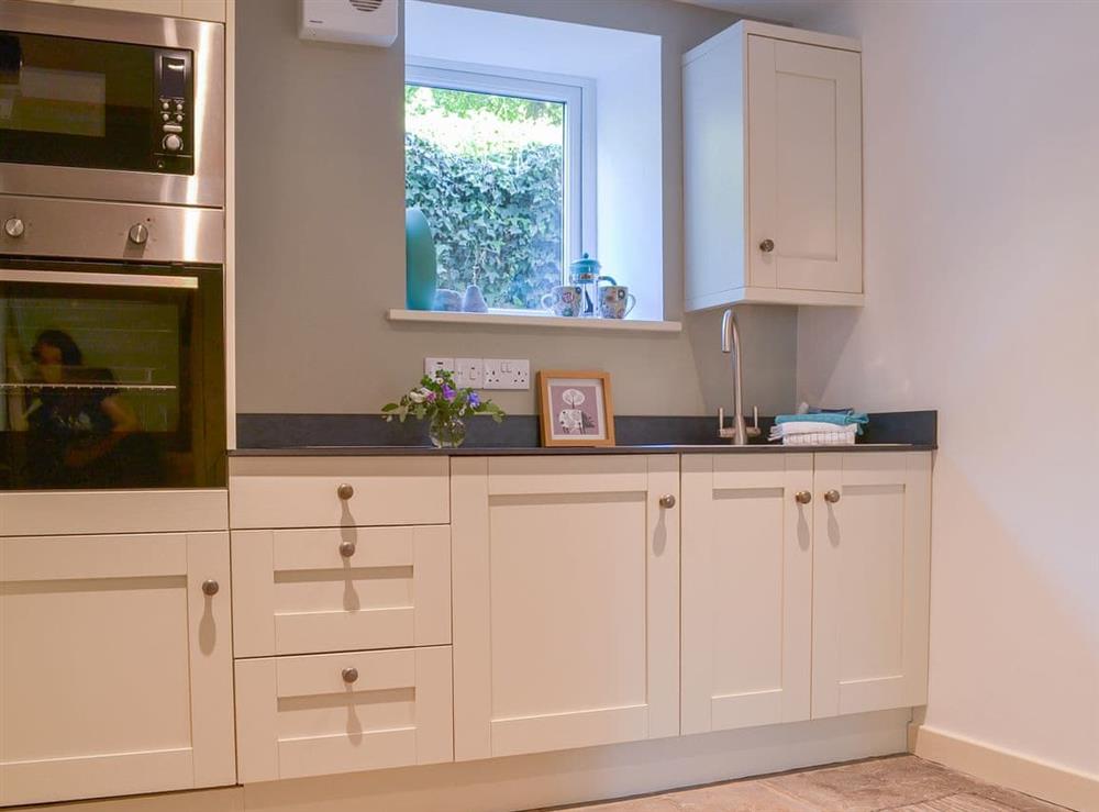Stone-floored and beamed kitchen at Clarence Cottage in Appleby-in-Westmorland, Cumbria