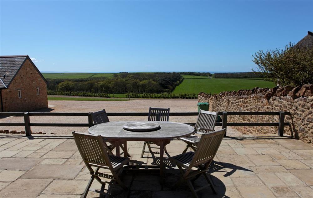 Garden furniture on the terrace with far reaching views at Clayhanger Lodge, Abbotsbury