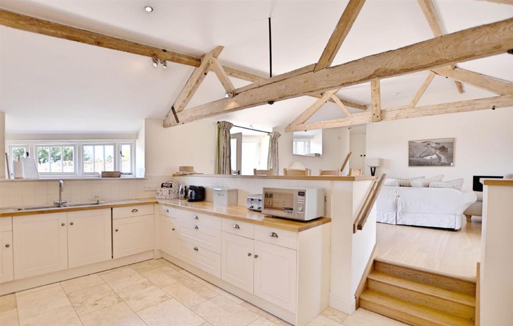 Kitchen with steps up to dining and sitting room on the upper ground floor at Clayhanger Lodge, Abbotsbury