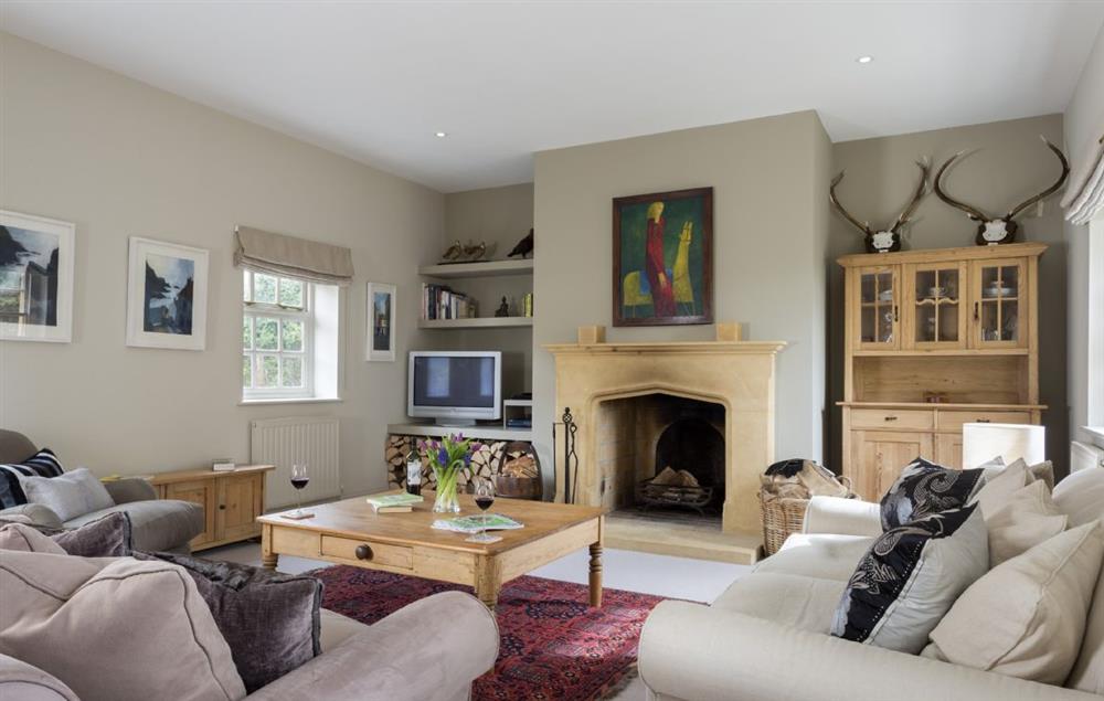 Sitting room with open fireplace at Claytons Cottage, Lower Oddington