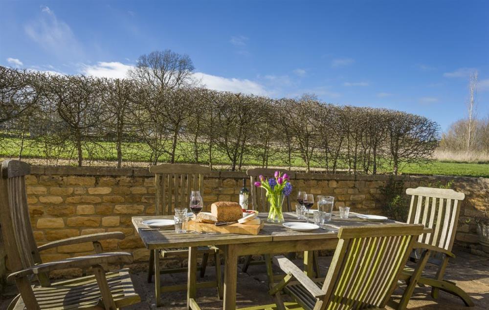 The rear patio terrace is ideal for outdoor dining (photo 2) at Claytons Cottage, Lower Oddington