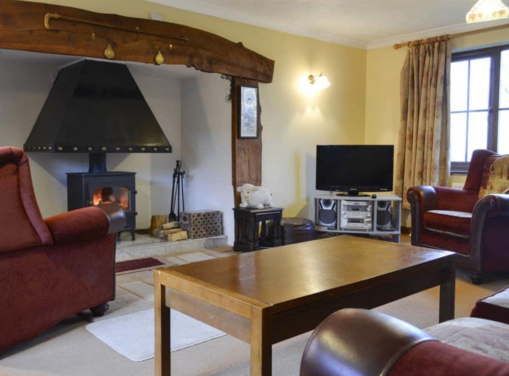 Cosy and warn living room with a large inglenook at Cleiriach in Llansannan, near Betws-y-Coed, Clwyd