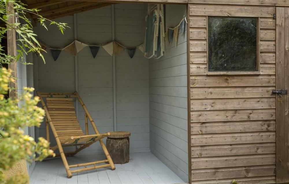 The enclosed cabin area with relaxed seating is perfect for whiling away a lazy afternoon at Clematis Cottage, Blockley