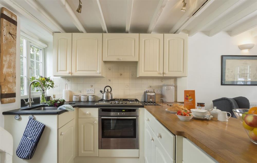 The fully equipped kitchen with a stable door leading out into an enclosed garden at Clematis Cottage, Blockley