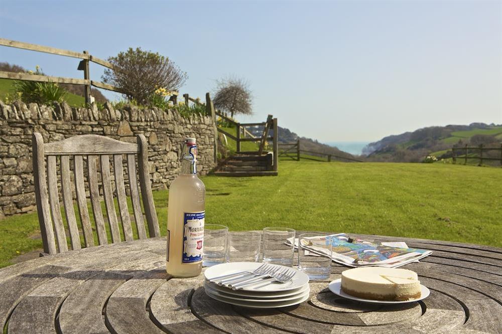 Enjoy dinner on the patio with views down the valley towards North Sands at Clementine Cottage in Malborough, Nr Salcombe