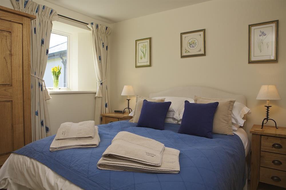 Master bedroom with King-size bed at Clementine Cottage in Malborough, Nr Salcombe