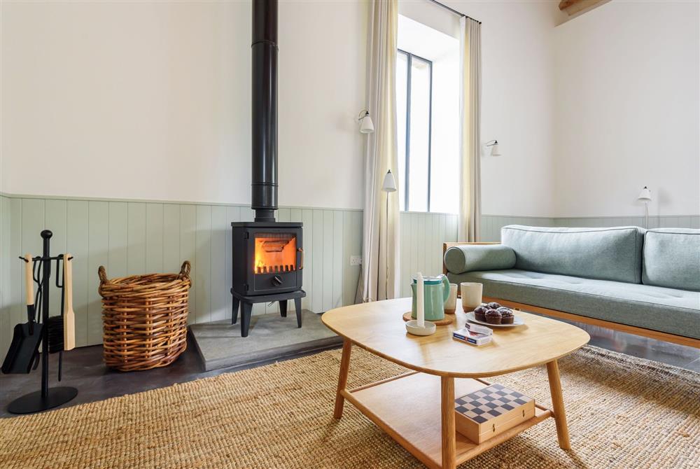 The sitting area with a wood burning stove for cosy nights in at Clementine, Dorchester