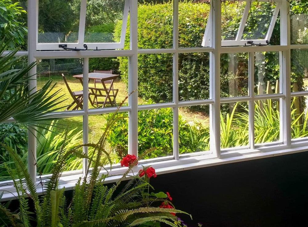 Conservatory with garden views at Vine Cottage, 