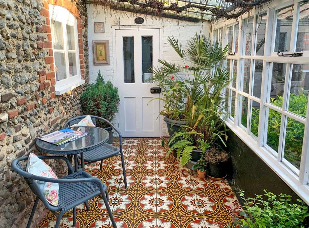 Relaxing conservatory with colourful tiles at Vine Cottage, 