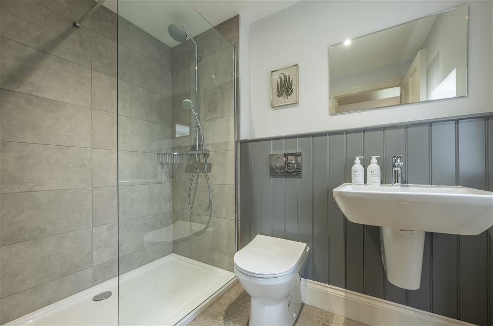 Bedroom four’s en-suite shower room with walk-in shower and heated towel rail at Cliff Farmhouse, Lincoln