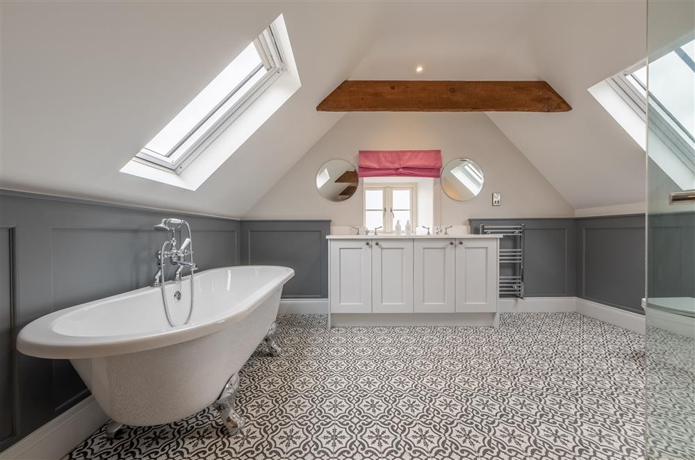 Bedroom one’s en-suite bathroom with roll-top bath at Cliff Farmhouse, Lincoln