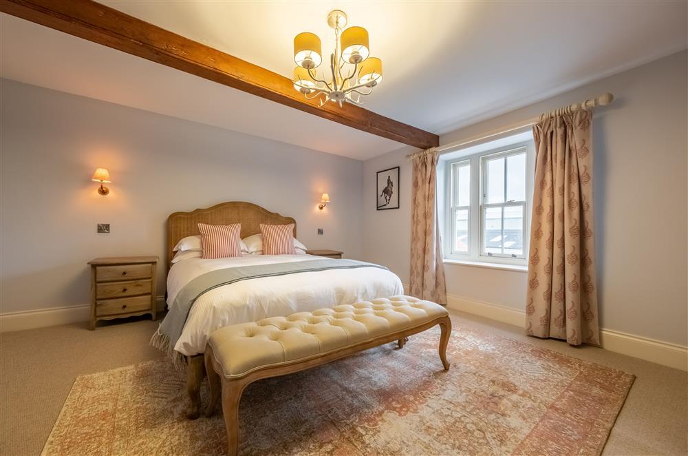 Bedroom three with a 5’ king-size bed and en-suite shower room  at Cliff Farmhouse, Lincoln