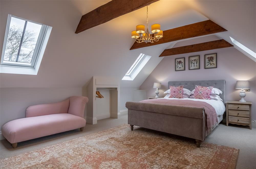 Exposed beams in spacious bedroom one on the second floor at Cliff Farmhouse, Lincoln
