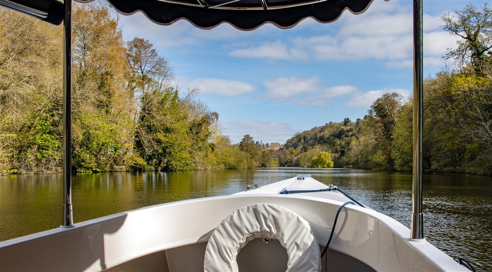 A view taken sitting inside a boat thats cruising down the river Thames at Cliveden Ferry Cottage in Nr Maidenhead, Berkshire