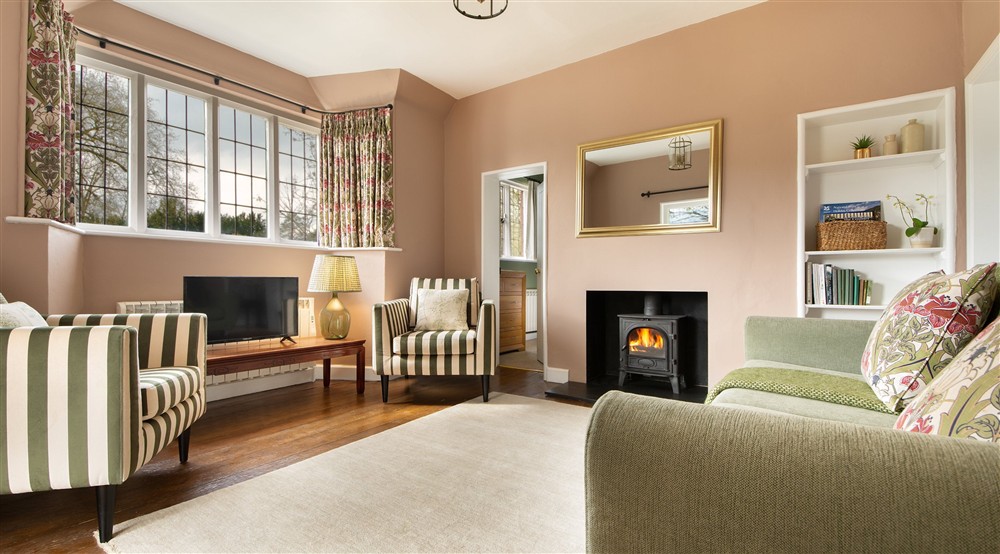 The sitting room with woodburner at Cliveden Ferry Cottage in Nr Maidenhead, Berkshire