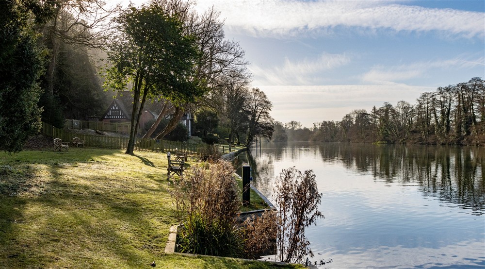 A view along the River Thames in Buckinghamshire with Spring Cottage in the background at Cliveden New Cottage in Nr Maidenhead, Berkshire