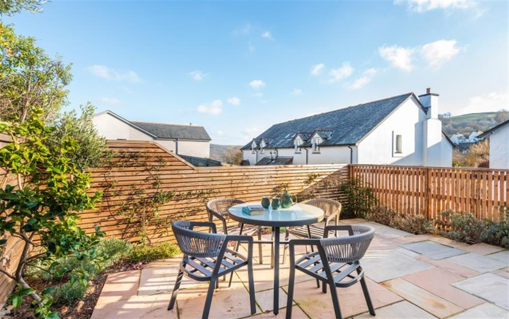 Private patio with table and chairs for 4 at Clock Cottage in Dittisham